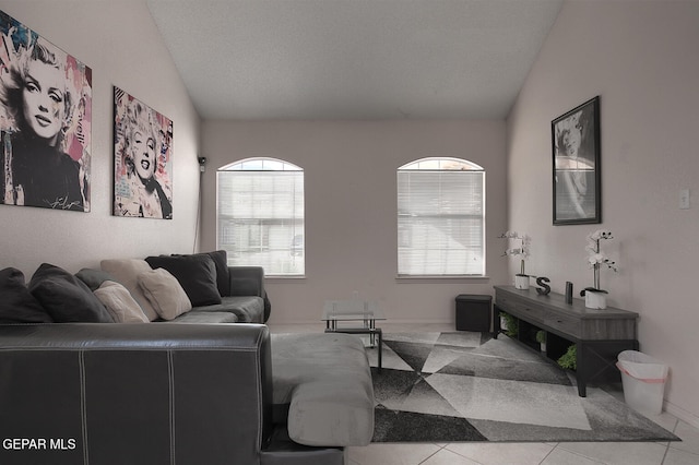 tiled living room featuring lofted ceiling and a textured ceiling