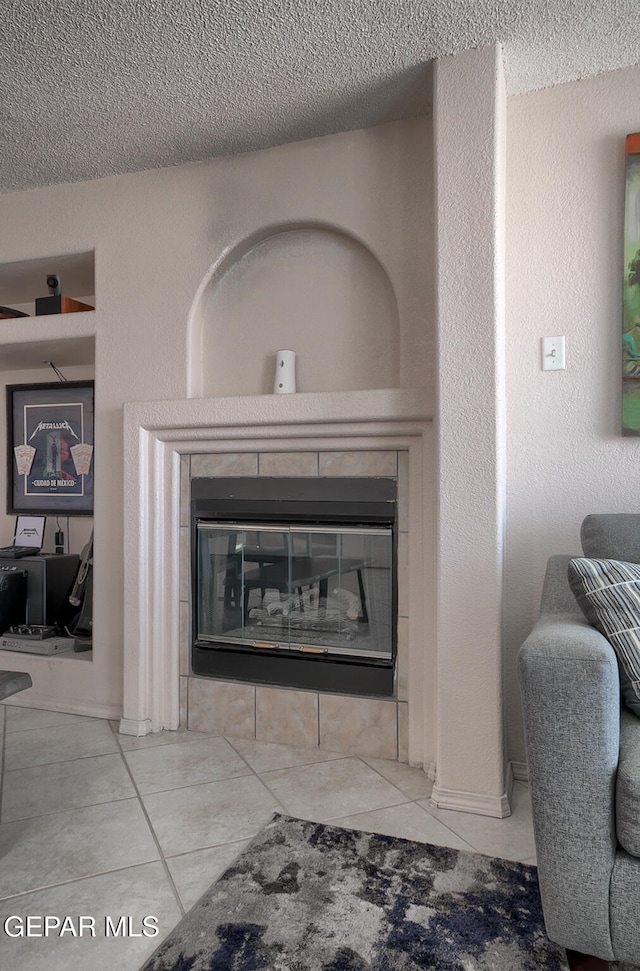 room details featuring a tile fireplace and a textured ceiling