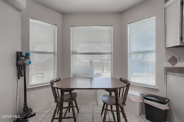 dining space featuring light tile patterned floors