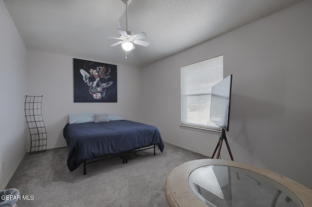 carpeted bedroom with a textured ceiling and ceiling fan