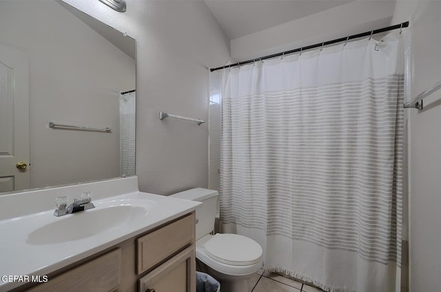 bathroom featuring vanity, tile patterned flooring, vaulted ceiling, and toilet