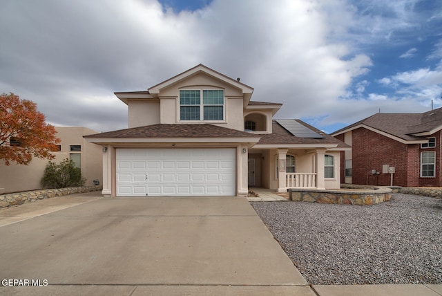 view of front of property with a garage and solar panels