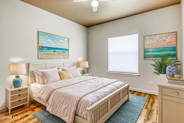 bedroom with ceiling fan and light wood-type flooring