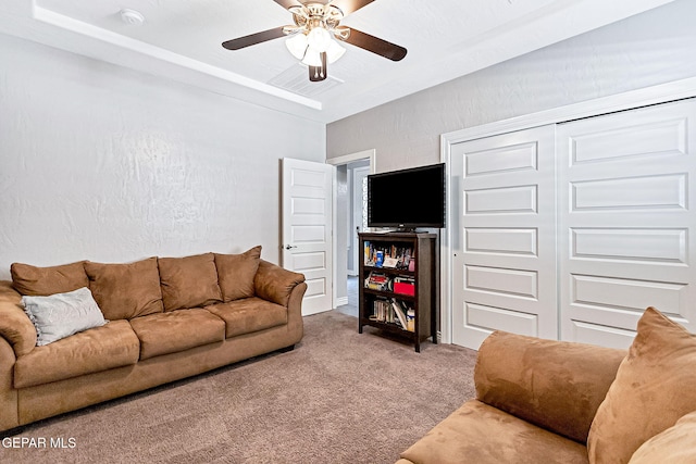 carpeted living room featuring ceiling fan