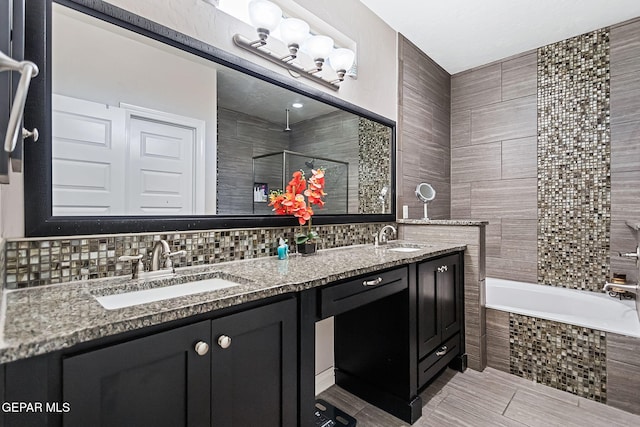 bathroom featuring vanity, backsplash, tile patterned floors, shower with separate bathtub, and tile walls