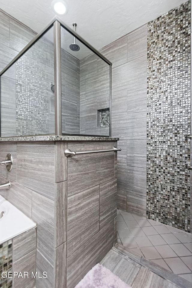 bathroom with a tile shower