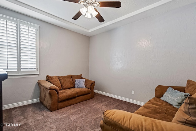 carpeted living room with ceiling fan