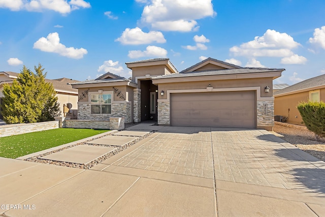 prairie-style home with a front yard and a garage