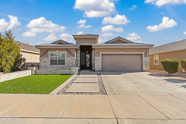 prairie-style house featuring a front yard and a garage