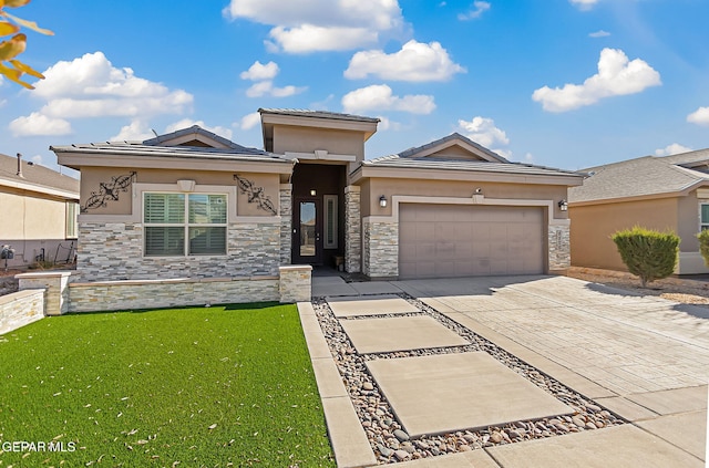 prairie-style home with a garage and a front lawn