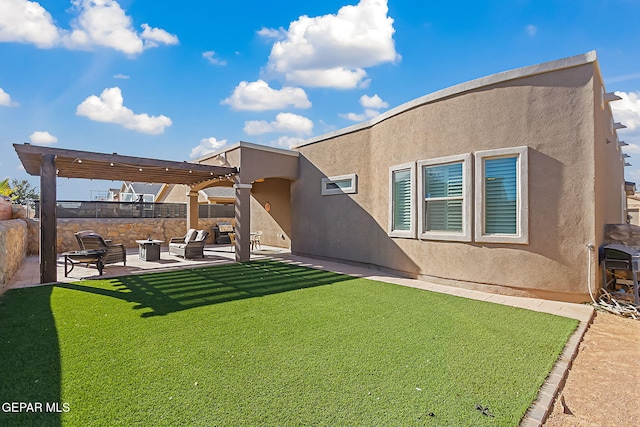 rear view of house featuring a pergola, a lawn, and a patio