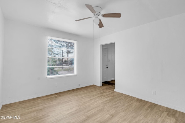 spare room featuring ceiling fan, a healthy amount of sunlight, and light wood-type flooring