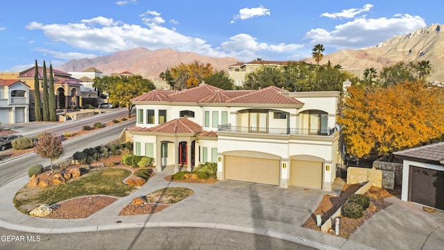 view of front of property with a mountain view and a balcony