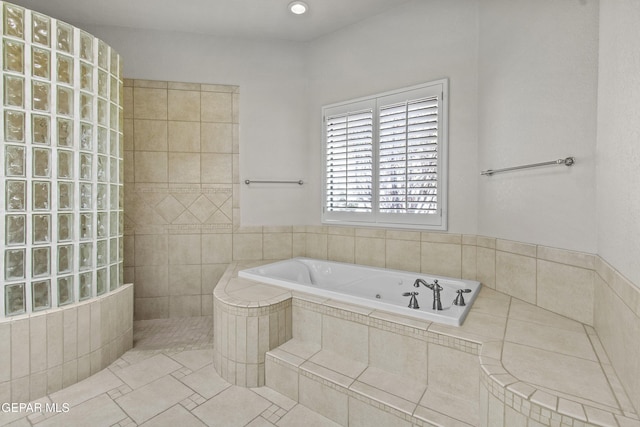 bathroom featuring tile patterned flooring and tiled shower