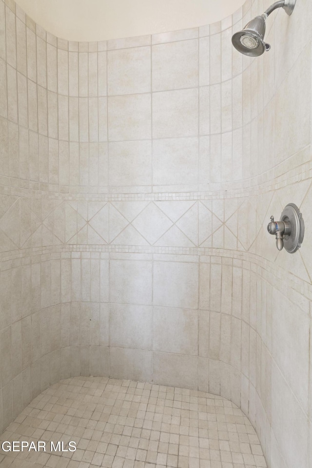 bathroom with tiled shower