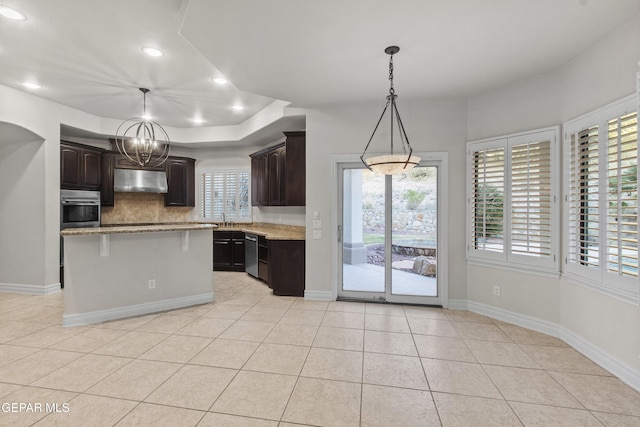 kitchen featuring a center island, sink, dark brown cabinets, light tile patterned flooring, and stainless steel appliances