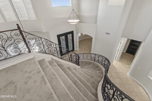 staircase featuring a high ceiling