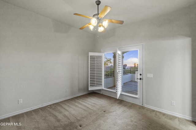 carpeted spare room featuring ceiling fan