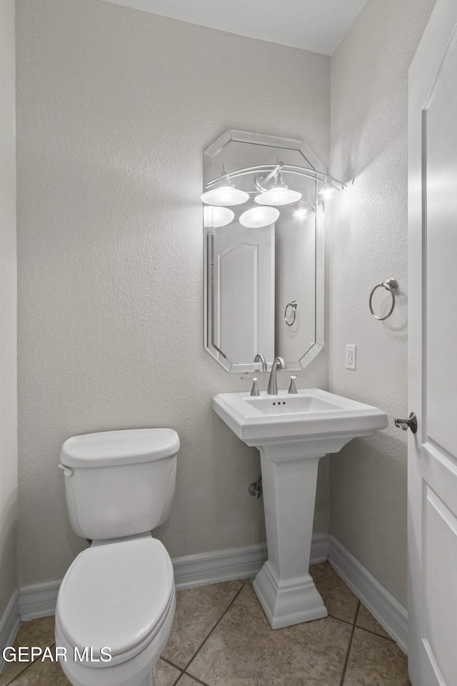 bathroom with sink, tile patterned flooring, and toilet