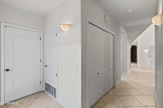 hall with light tile patterned flooring