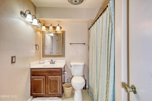 bathroom with vanity, toilet, and walk in shower