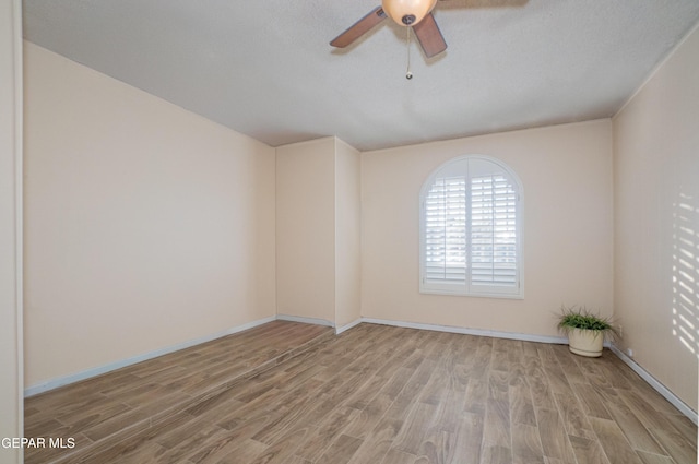 unfurnished room featuring ceiling fan, light hardwood / wood-style floors, and a textured ceiling