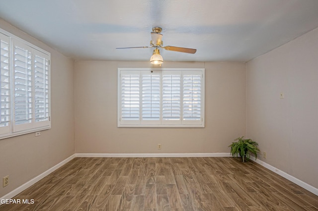 unfurnished room with hardwood / wood-style flooring and ceiling fan