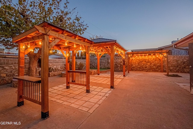 patio terrace at dusk featuring a gazebo