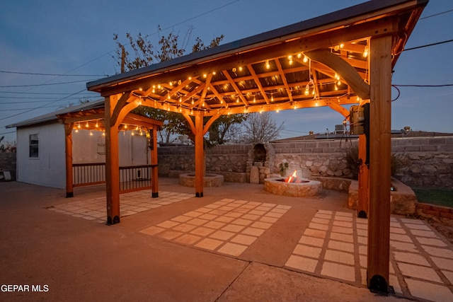 patio terrace at dusk with a gazebo and an outdoor fire pit