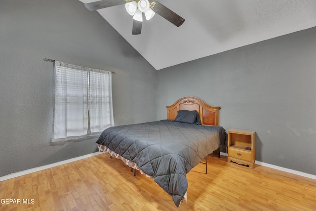 bedroom featuring high vaulted ceiling, light hardwood / wood-style flooring, and ceiling fan