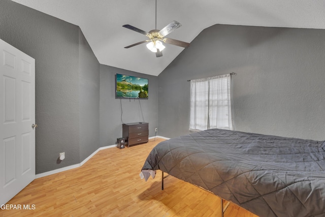 bedroom featuring ceiling fan, light hardwood / wood-style flooring, and vaulted ceiling