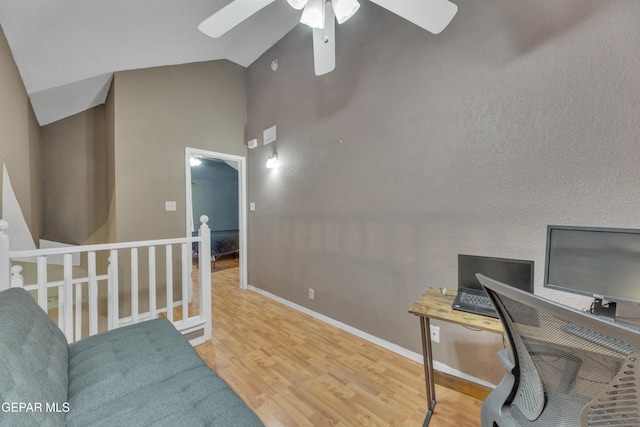 office with hardwood / wood-style flooring, ceiling fan, and high vaulted ceiling