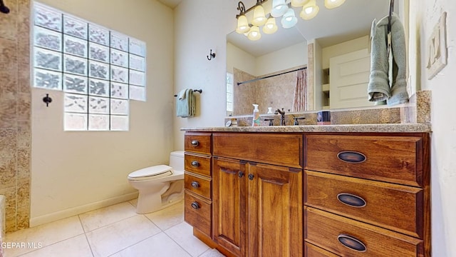 bathroom featuring tile patterned floors, vanity, and toilet