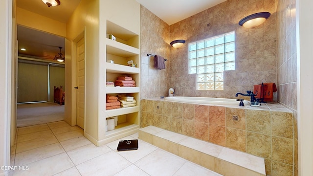 bathroom with tile patterned flooring, built in features, tile walls, and tiled tub