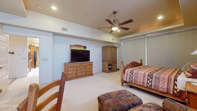 carpeted bedroom with stainless steel fridge and ceiling fan