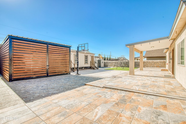 view of patio featuring a storage unit