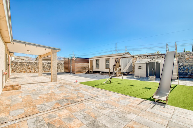 view of patio / terrace featuring a storage unit