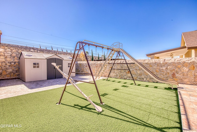 view of jungle gym with a shed