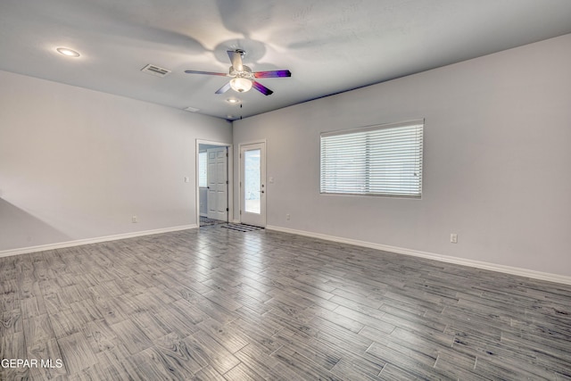 spare room with hardwood / wood-style floors and ceiling fan