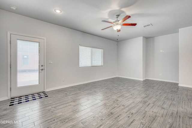 unfurnished room with ceiling fan and light hardwood / wood-style floors