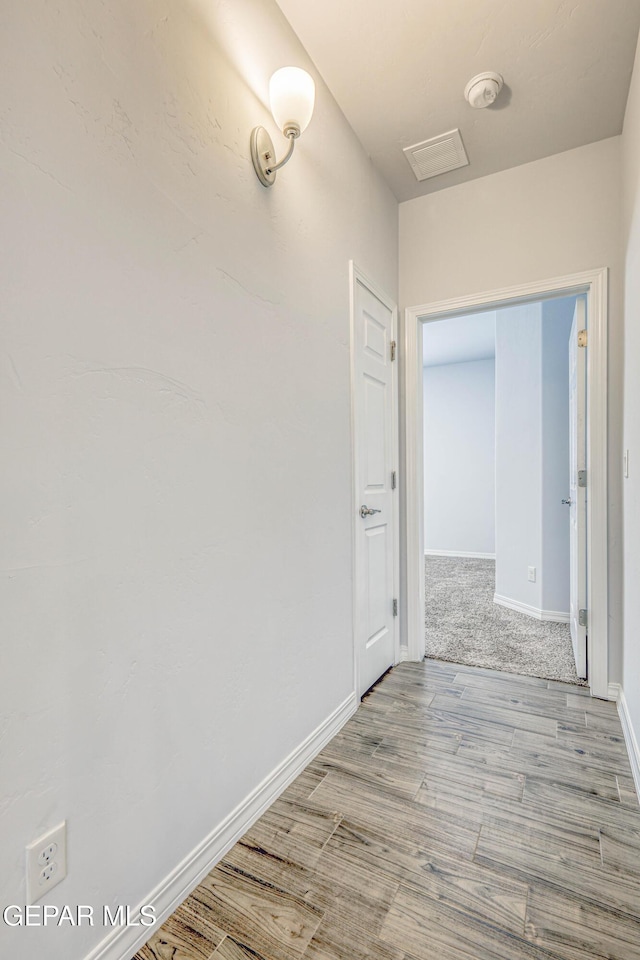 hall with light hardwood / wood-style flooring