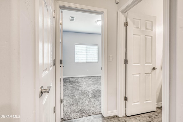 hall with light wood-type flooring