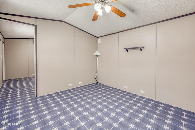 basement with ceiling fan, ornamental molding, and a textured ceiling