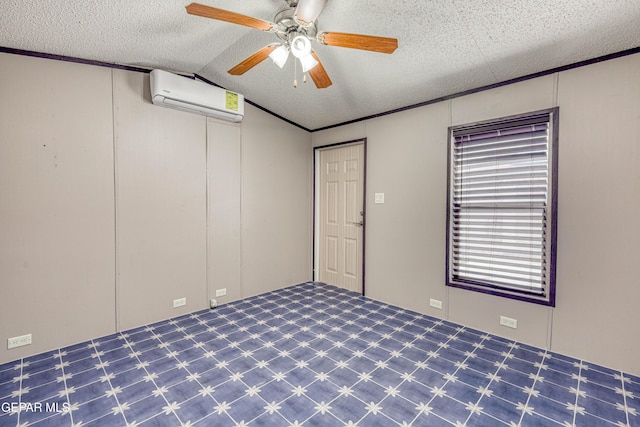 unfurnished room with lofted ceiling, an AC wall unit, and a textured ceiling