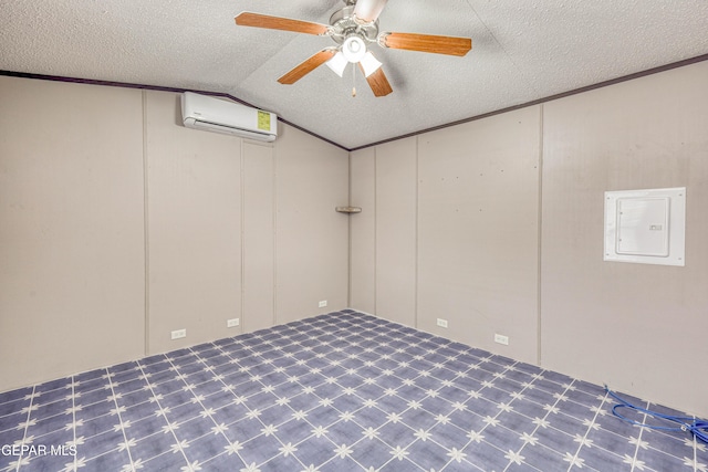 basement featuring ceiling fan, an AC wall unit, a textured ceiling, and electric panel