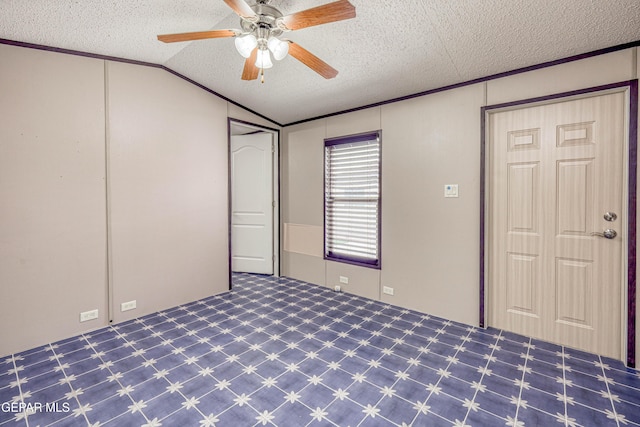 unfurnished bedroom featuring ornamental molding, a textured ceiling, ceiling fan, and lofted ceiling