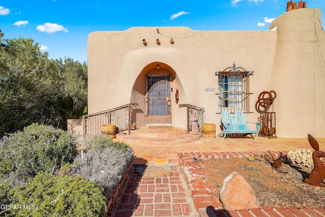 doorway to property featuring a patio