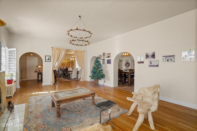 living room featuring hardwood / wood-style flooring and a chandelier