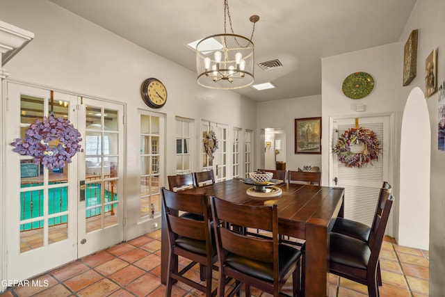 dining space with a notable chandelier and french doors