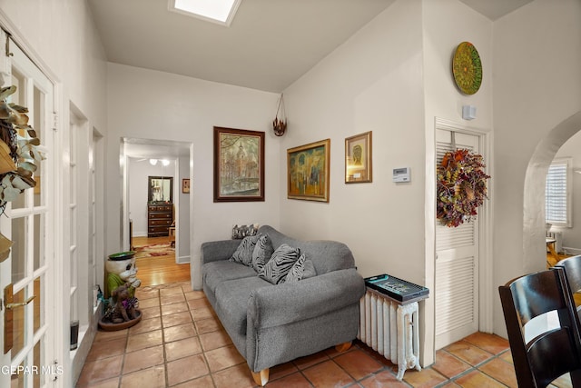 1117 Kerbey Ave, El Paso, TX 79902 - living area featuring light tile patterned flooring and arched walkways